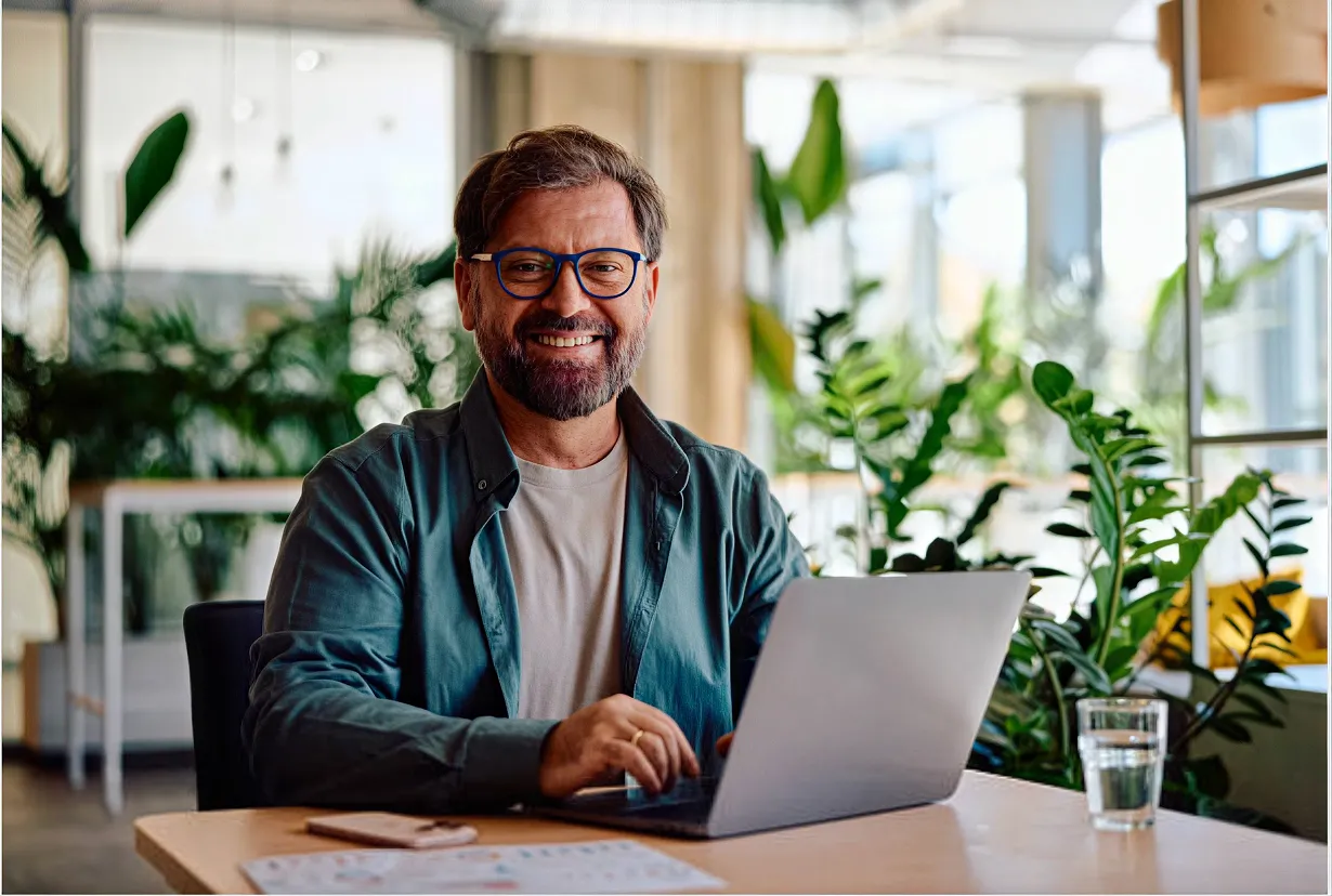 A relieved landlord at a laptop, records organized at tax time